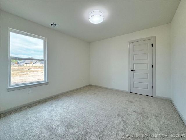 spare room with light carpet