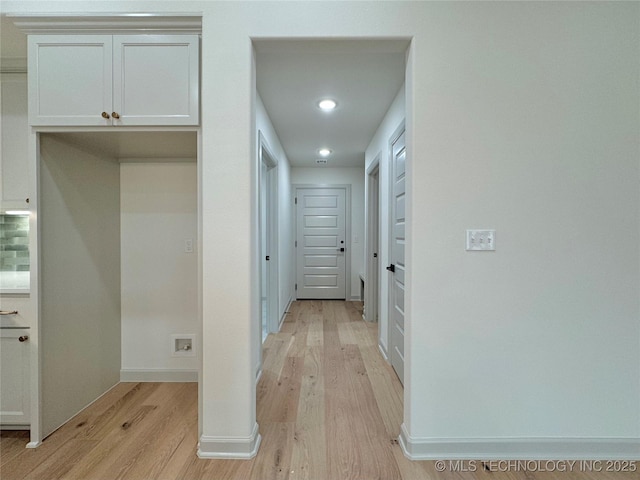 hallway with light hardwood / wood-style floors