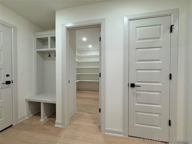 mudroom with light hardwood / wood-style flooring