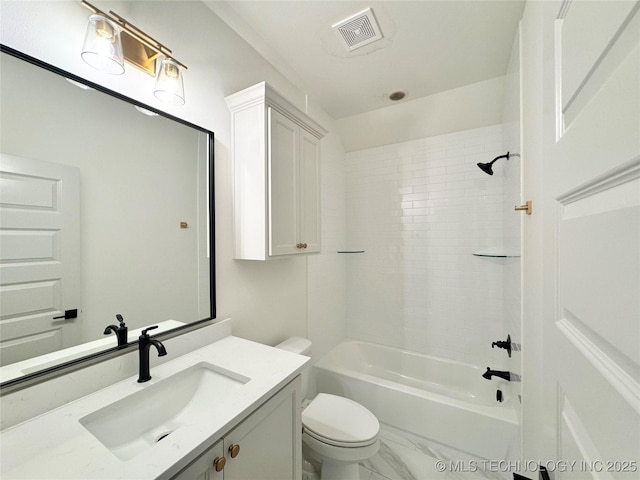 full bathroom with tiled shower / bath, vanity, and toilet