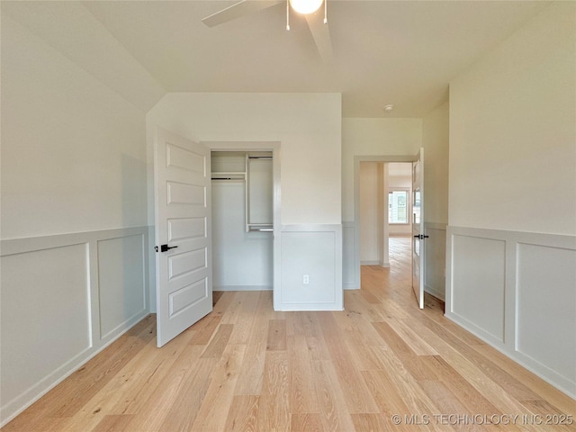 unfurnished bedroom with a closet, ceiling fan, and light wood-type flooring