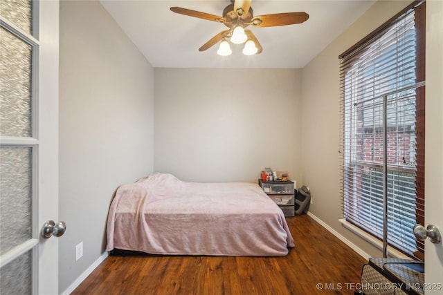 bedroom with dark wood-type flooring and ceiling fan