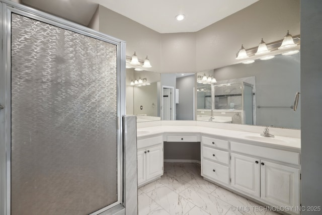 full bath featuring a sink, a shower stall, double vanity, and marble finish floor