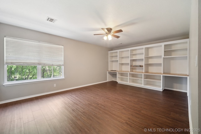 unfurnished room featuring ceiling fan, visible vents, dark wood-style floors, and baseboards