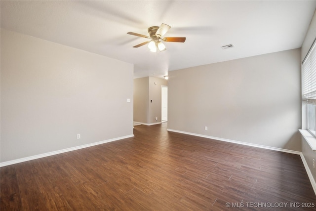 unfurnished room featuring ceiling fan and dark hardwood / wood-style flooring