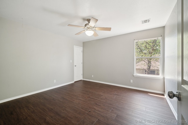 unfurnished room featuring visible vents, dark wood-type flooring, baseboards, and ceiling fan