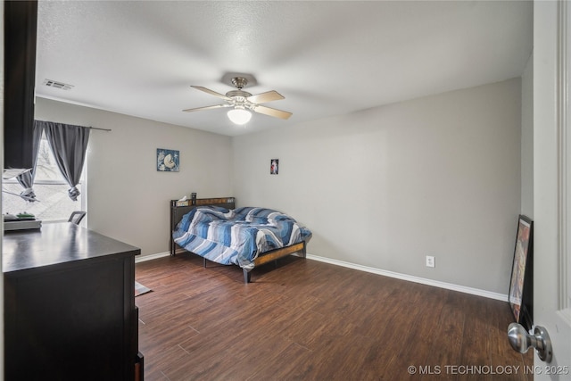 bedroom with ceiling fan and dark hardwood / wood-style floors