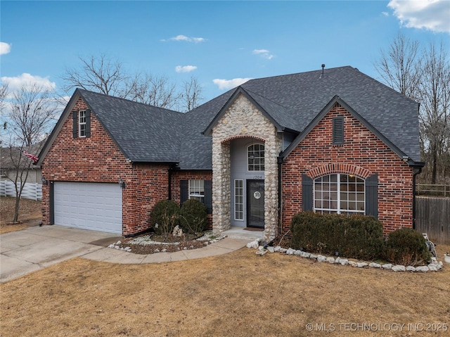 view of front facade featuring fence, a shingled roof, brick siding, a front yard, and driveway