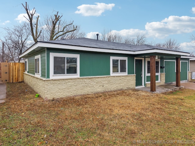 back of house with a lawn