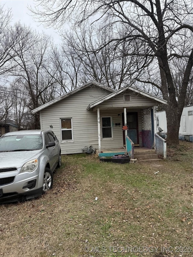 view of front of house with a porch and a front lawn