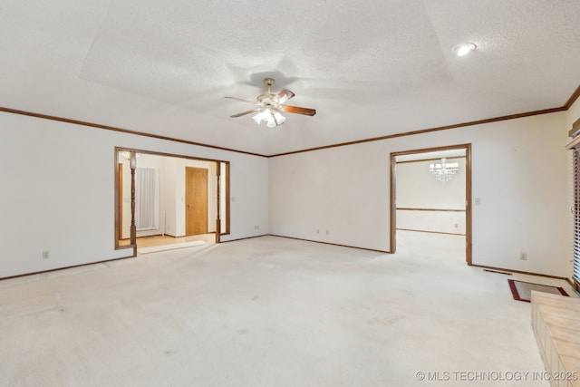 carpeted empty room featuring ornamental molding, ceiling fan, and a textured ceiling