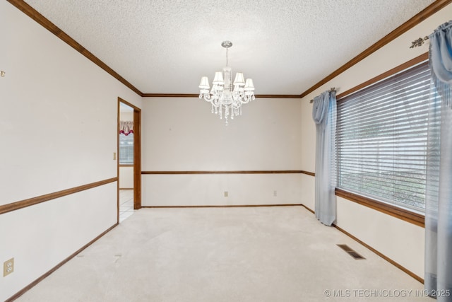 carpeted empty room featuring crown molding, a notable chandelier, and a textured ceiling