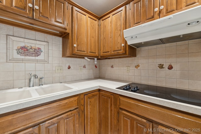 kitchen with tasteful backsplash, black electric stovetop, and sink