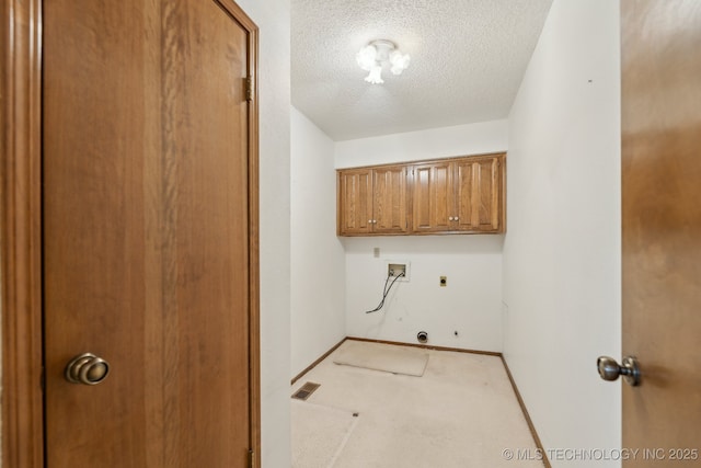 laundry room with cabinets, hookup for a washing machine, electric dryer hookup, light carpet, and a textured ceiling