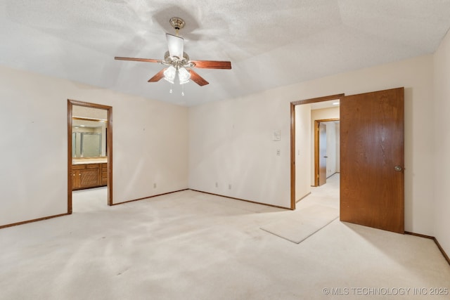 unfurnished room with ceiling fan, light colored carpet, and a textured ceiling