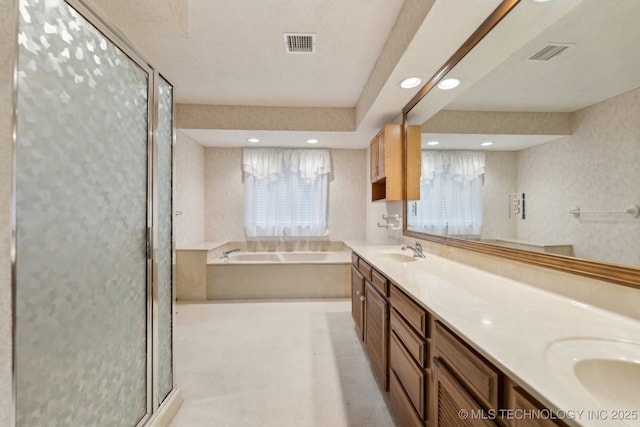 bathroom featuring vanity, a wealth of natural light, and plus walk in shower