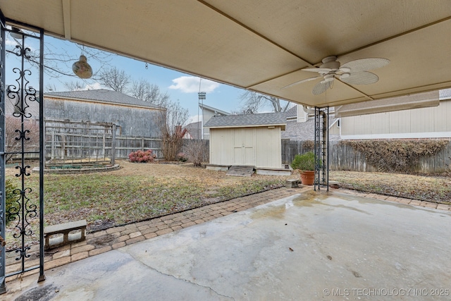 view of patio / terrace with ceiling fan and a storage unit