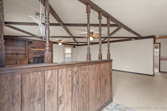 unfurnished living room with ceiling fan, coffered ceiling, a fireplace, a textured ceiling, and beamed ceiling