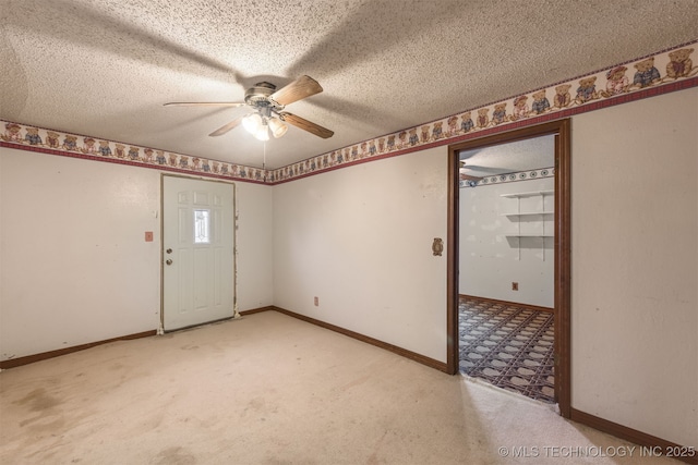 empty room featuring light carpet, ceiling fan, and a textured ceiling