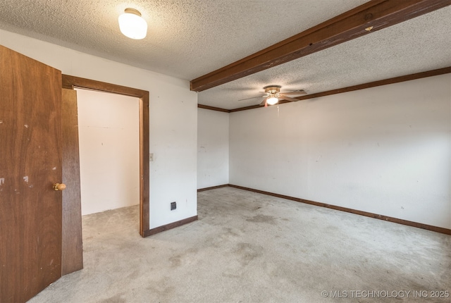 carpeted spare room featuring ceiling fan and a textured ceiling