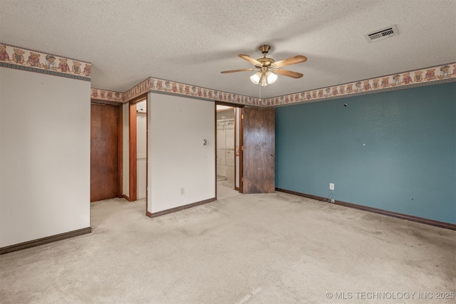 unfurnished bedroom featuring ceiling fan, carpet, and a textured ceiling