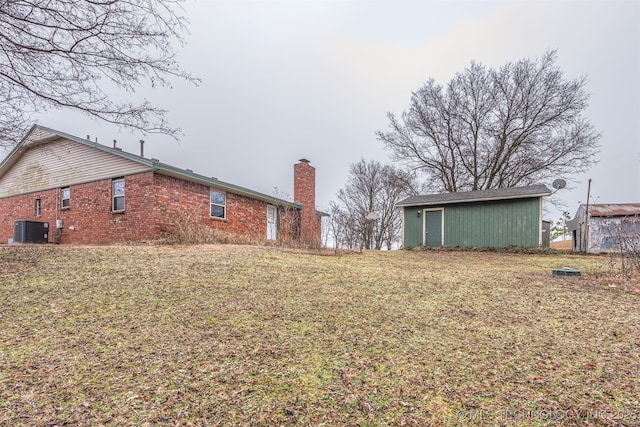 view of yard with an outbuilding and central AC unit