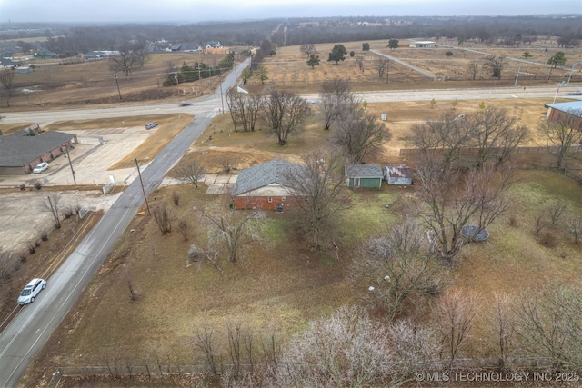 birds eye view of property with a rural view