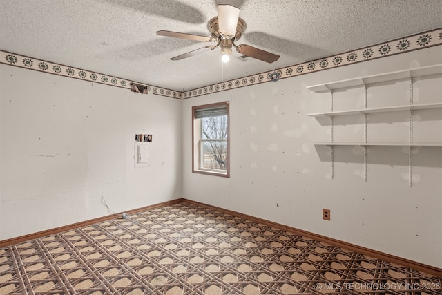 empty room featuring ceiling fan and a textured ceiling