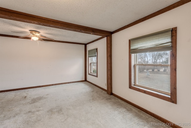 carpeted empty room with ceiling fan and a textured ceiling