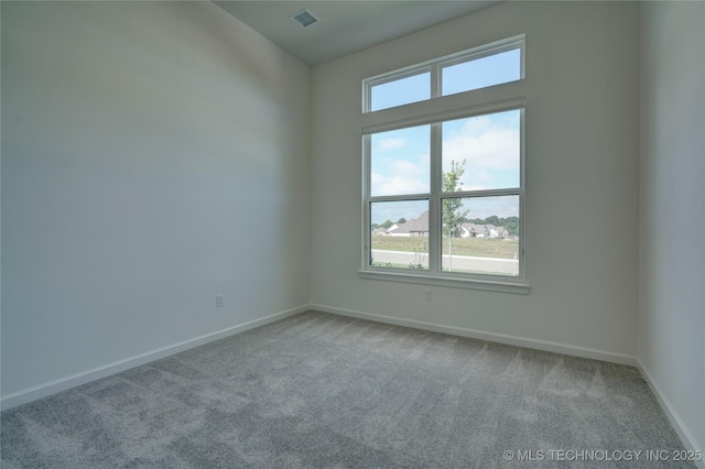 spare room featuring light colored carpet