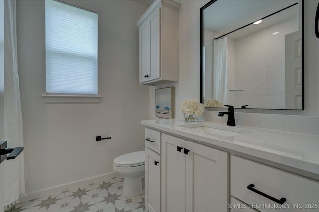 bathroom with vanity, curtained shower, and toilet