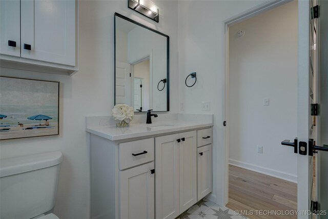 bathroom featuring vanity, hardwood / wood-style floors, and toilet