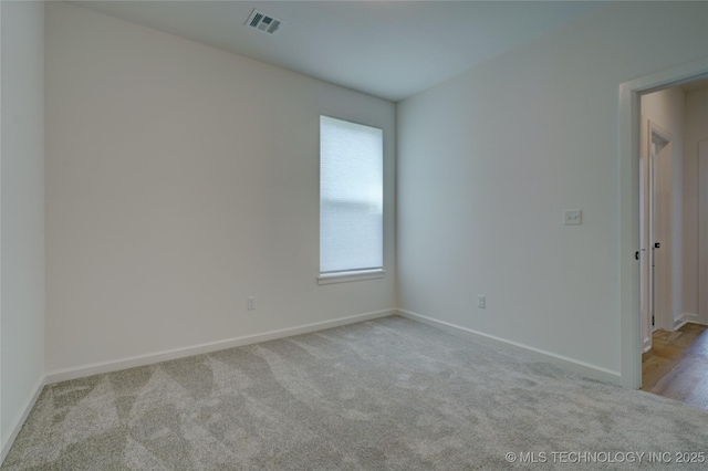 unfurnished room with light carpet