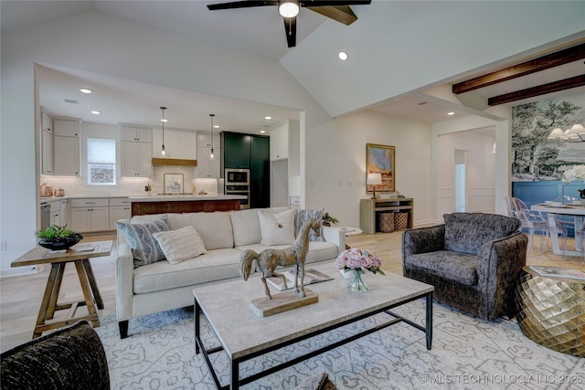 living room with vaulted ceiling with beams, ceiling fan, and light wood-type flooring