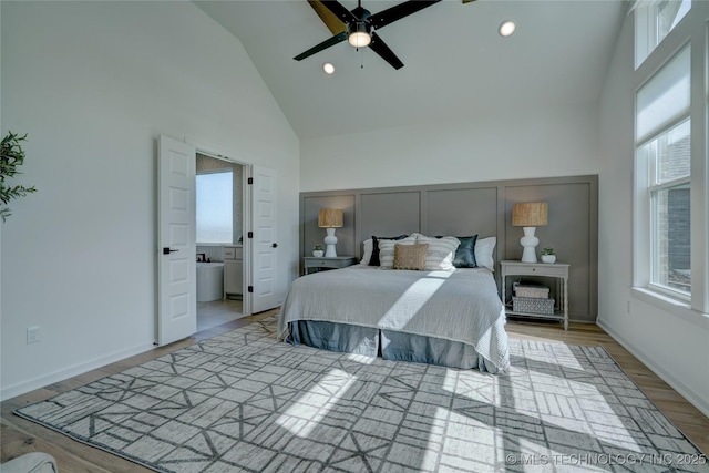 bedroom with high vaulted ceiling and light hardwood / wood-style flooring