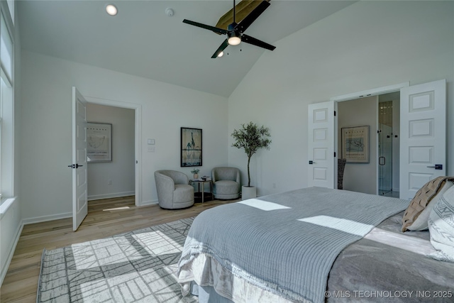 bedroom with ceiling fan, high vaulted ceiling, and light wood-type flooring