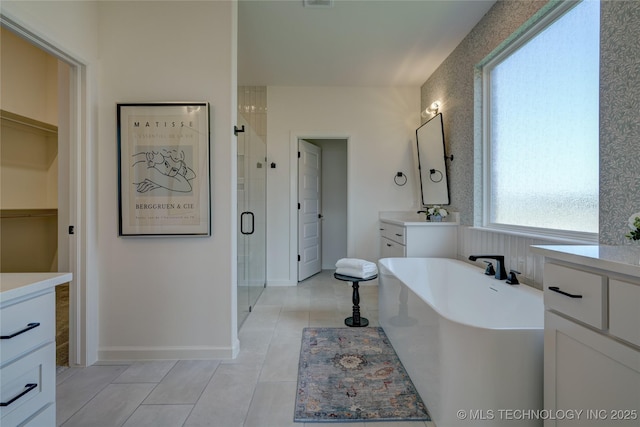 bathroom featuring independent shower and bath, vanity, and tile patterned floors