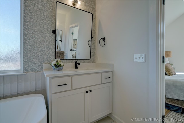 bathroom with a tub to relax in and vanity