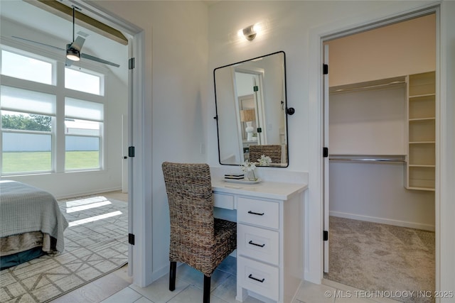 bedroom with light carpet and built in desk