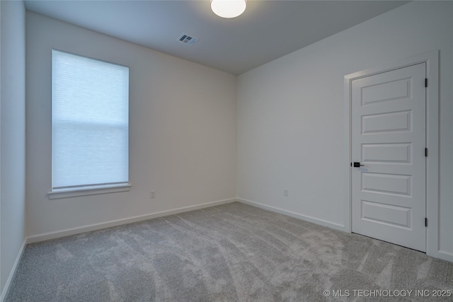 empty room featuring light carpet