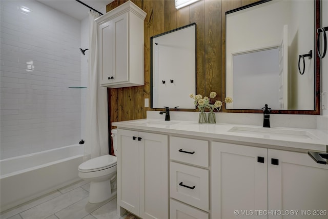 full bathroom featuring tiled shower / bath combo, vanity, toilet, and wood walls