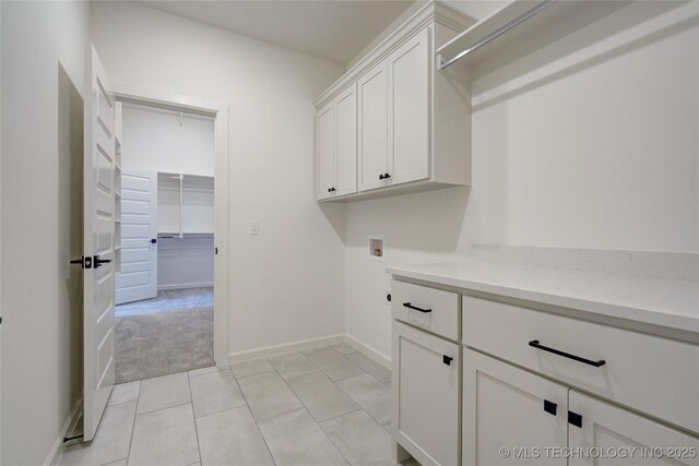 laundry area with light colored carpet, cabinets, and hookup for a washing machine