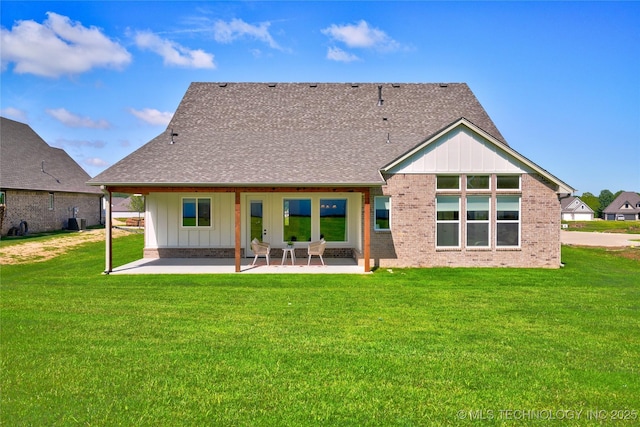 back of property with central AC, a patio, and a lawn