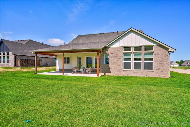 back of house with a yard and a patio