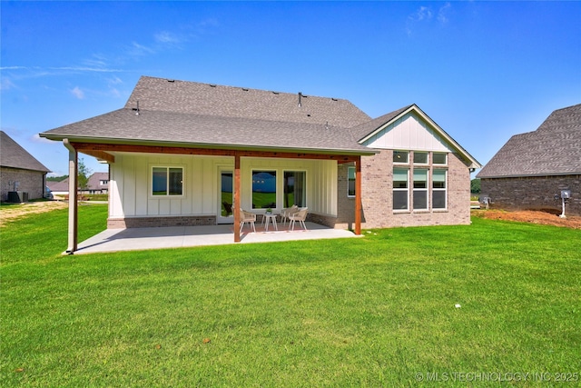 rear view of house with a patio and a yard