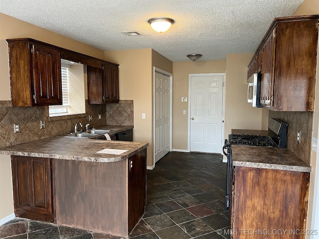 kitchen with dark brown cabinetry, sink, a textured ceiling, appliances with stainless steel finishes, and decorative backsplash