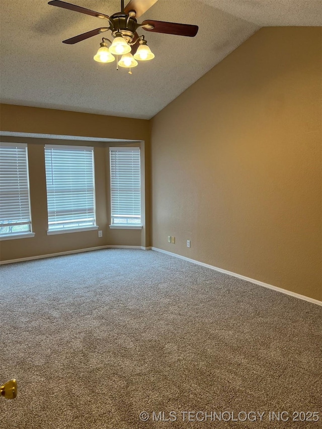 unfurnished room with lofted ceiling, ceiling fan, a textured ceiling, and carpet