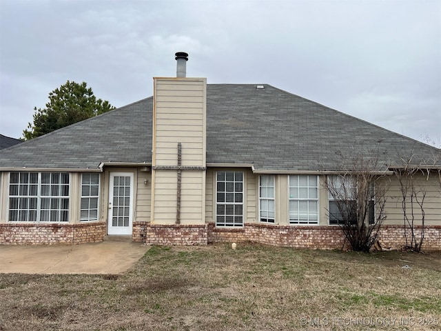 back of property featuring a yard and a patio