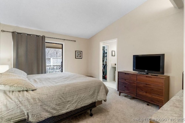 carpeted bedroom with a spacious closet and vaulted ceiling