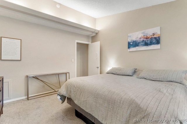 carpeted bedroom with a textured ceiling